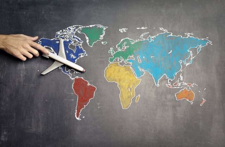 Caro biglietti aerei: perchè? person with toy airplane on world map